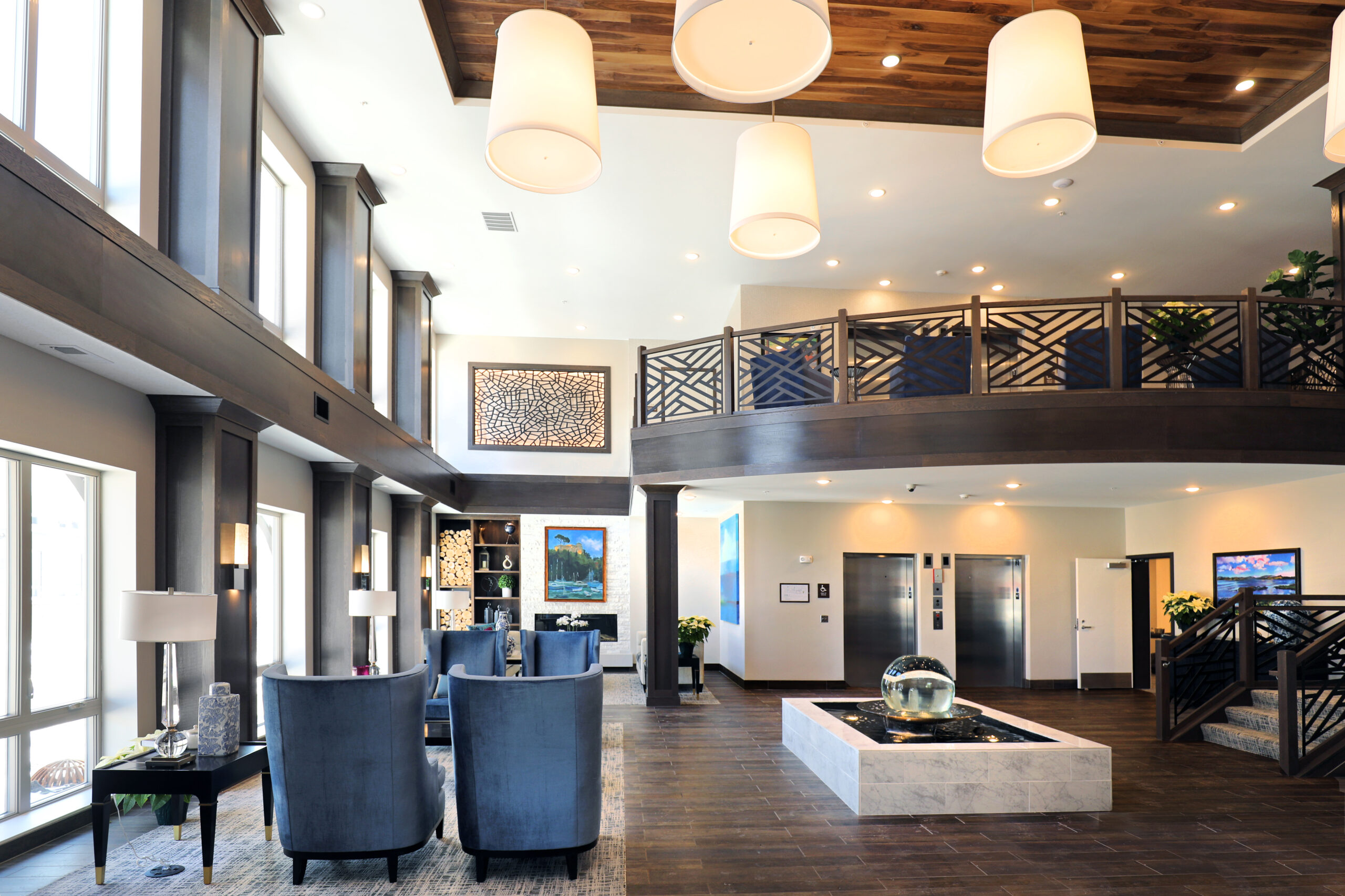 Assisted living senior community common area lobby with chairs and balcony stylish design interior in golden valley mn