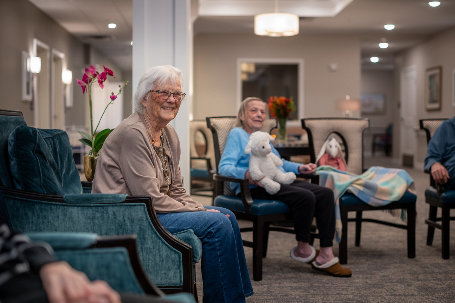 two women smiling stuffed animals common room senior living assisted living facility apartments memory care patients golden valley minnesota